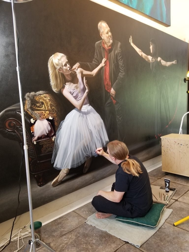 Florida artist Kevin Grass works on his large Not #MeToo: No More Casting Couch painting in his living room. 