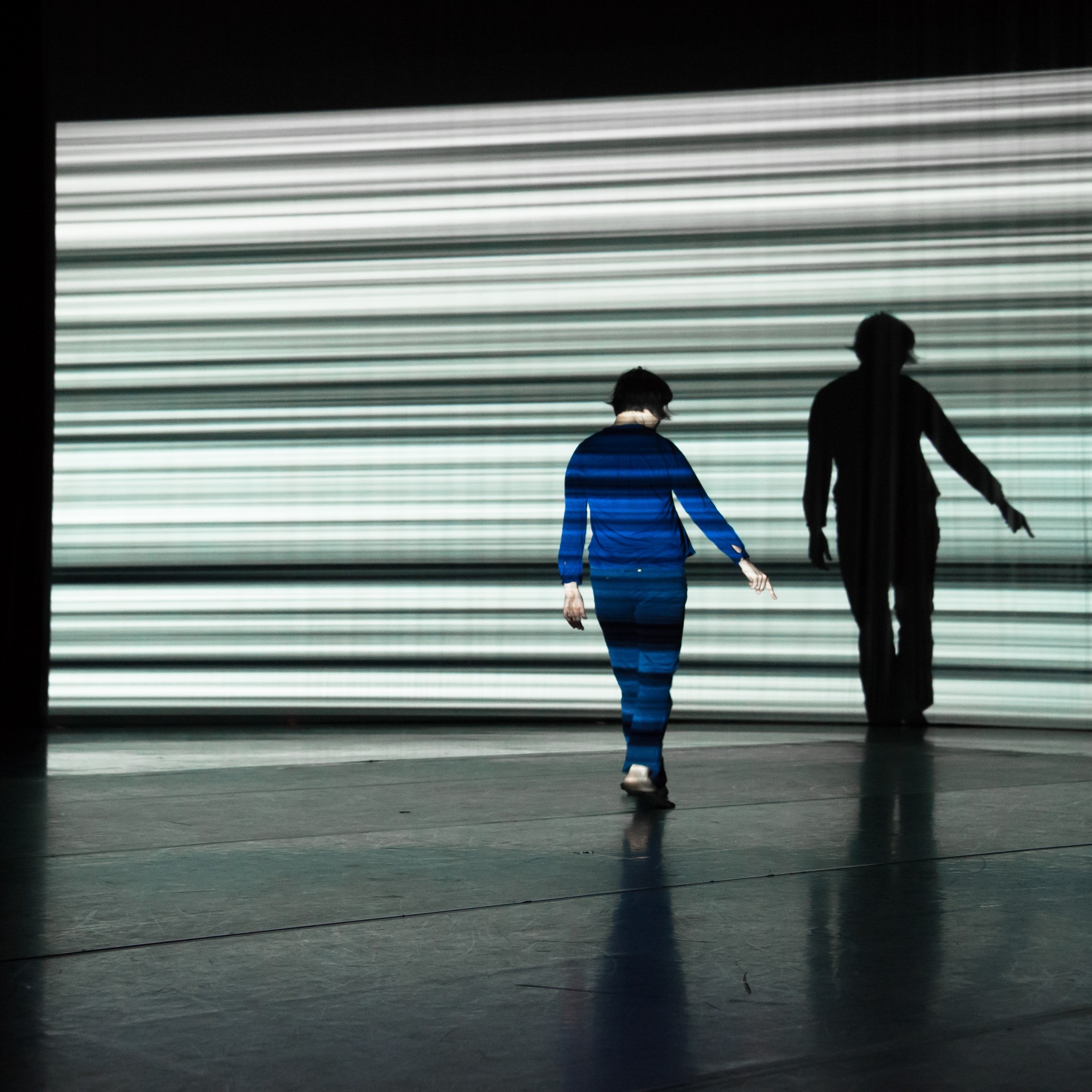 Solo dancer in front of video projection