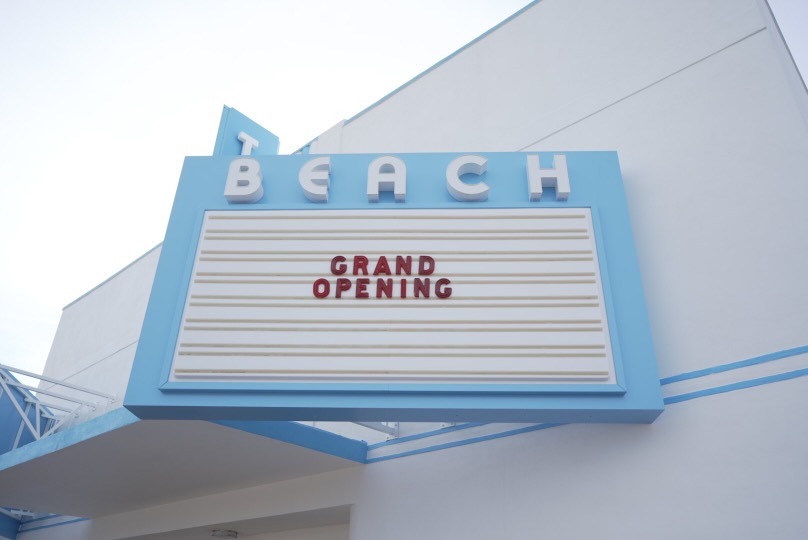 A theater's marquis reads Grand Opening.